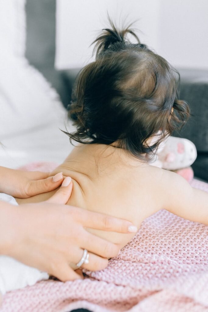 photo of a baby getting a back massage